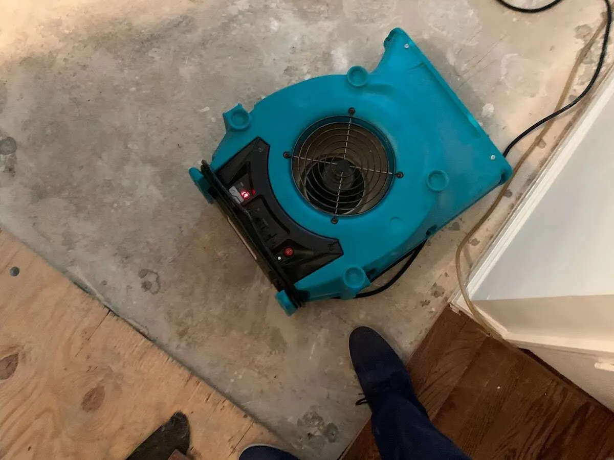 Air mover drying subfloor during Leak Detection & Repair in Waterloo